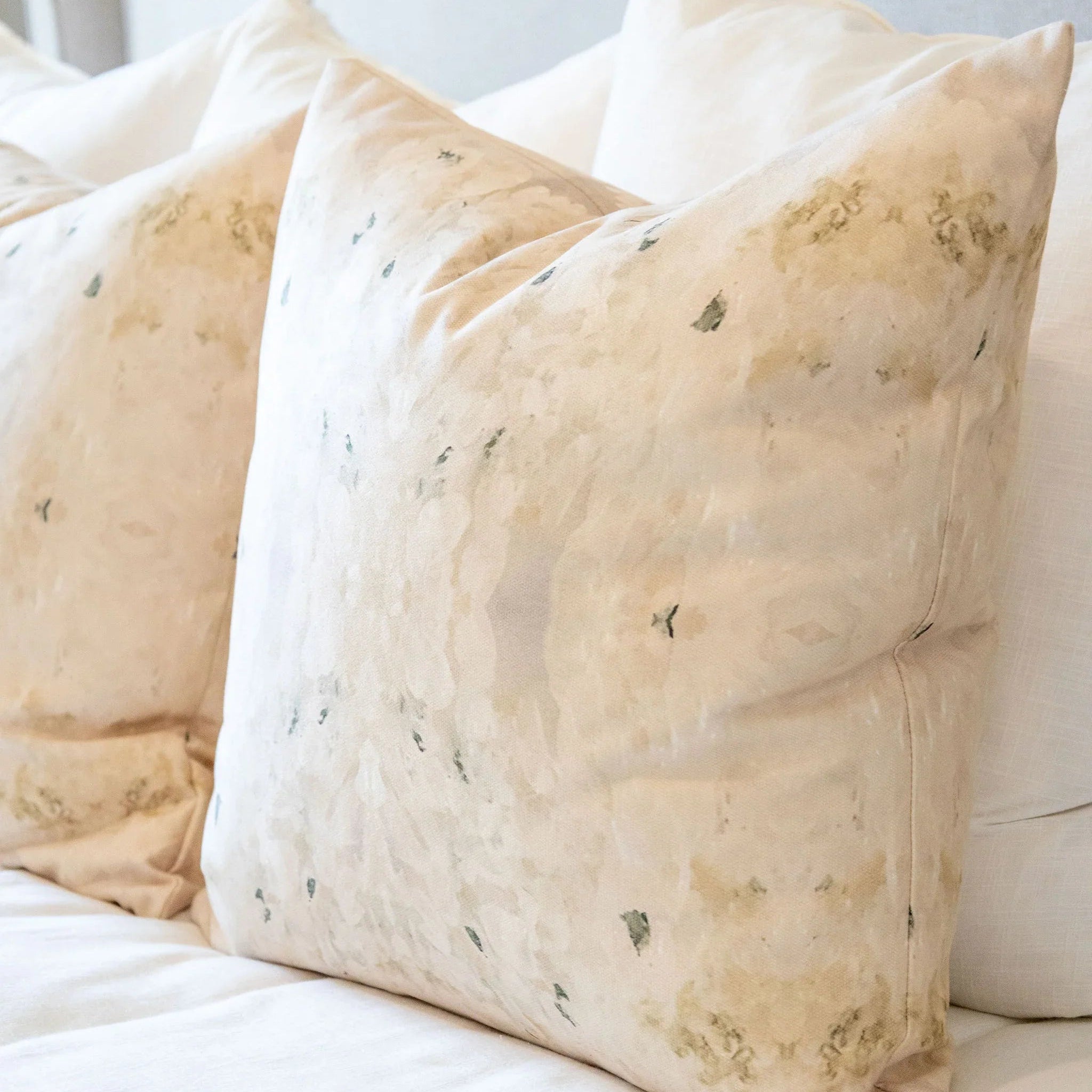 Centerpiece White Hydrangea luxury decorative pillow featuring a large-scale abstract floral pattern in layered white, cream, and deep olive green tones, handcrafted in England for luxury living rooms, designer-curated interiors, tailored upholstery, and thoughtfully layered homes.