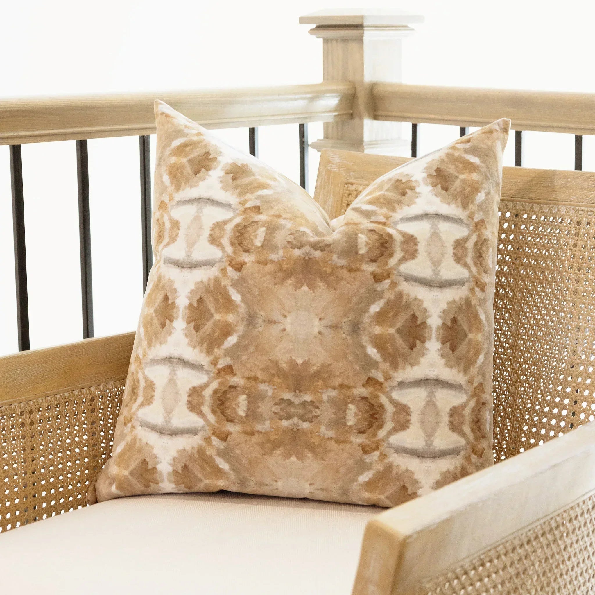 Luxury decorative pillow featuring an organic tree-inspired pattern in warm cognac and neutral tones, styled for a layered modern traditional interior.