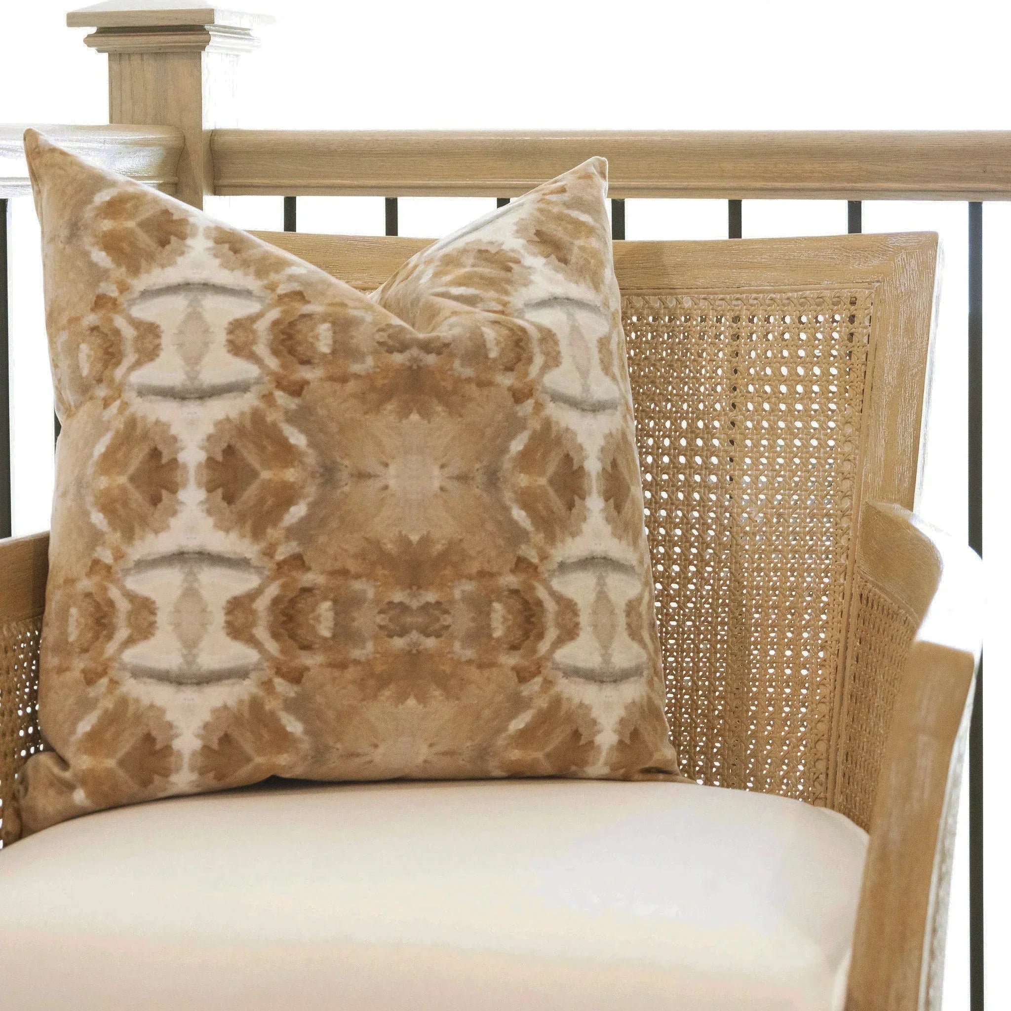 Luxury decorative pillow featuring an organic tree-inspired pattern in warm cognac and neutral tones, styled for a layered modern traditional interior.