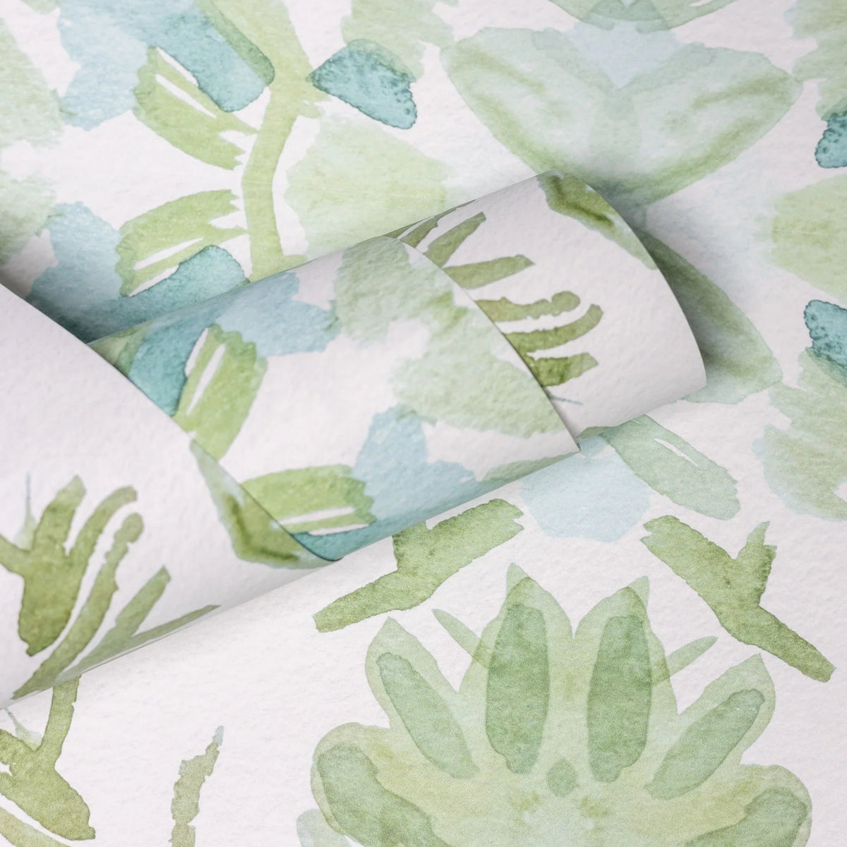 Luxury botanical wallpaper featuring an artistic wildflower-inspired pattern in sage green and soft blue, designed for modern traditional interiors, powder rooms, bedrooms, dining rooms, and collected homes.