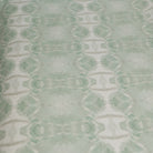 Luxury abstract botanical fabric featuring layered tree-inspired movement in calming jade green and soft neutral tones for collected modern traditional interiors.
