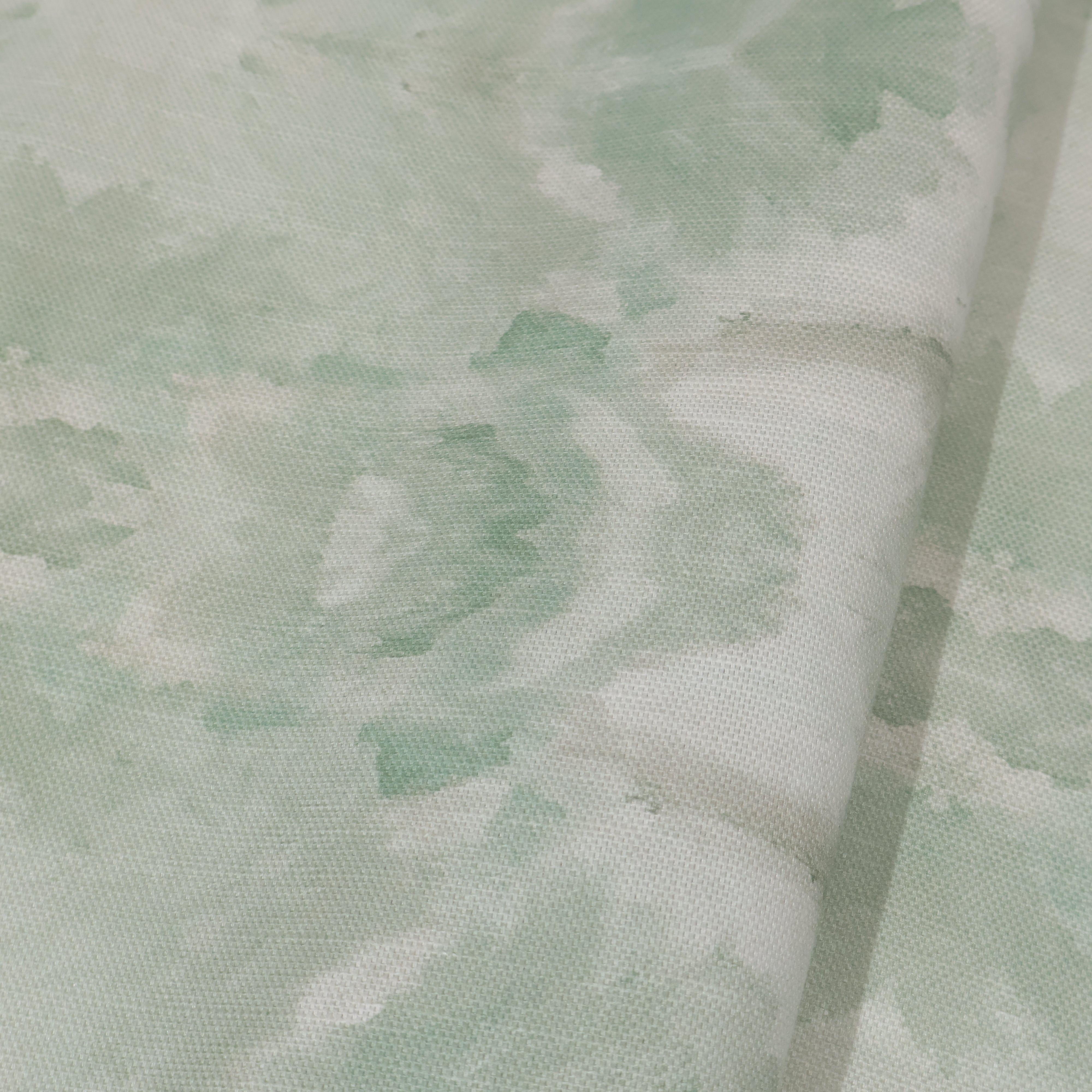 Luxury abstract botanical fabric featuring layered tree-inspired movement in calming jade green and soft neutral tones for collected modern traditional interiors.
