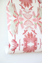 Luxury floral wallpaper featuring an artistic wildflower pattern in strawberry pink, blush, and soft green tones, designed for modern traditional interiors, bedrooms, powder rooms, and collected homes.