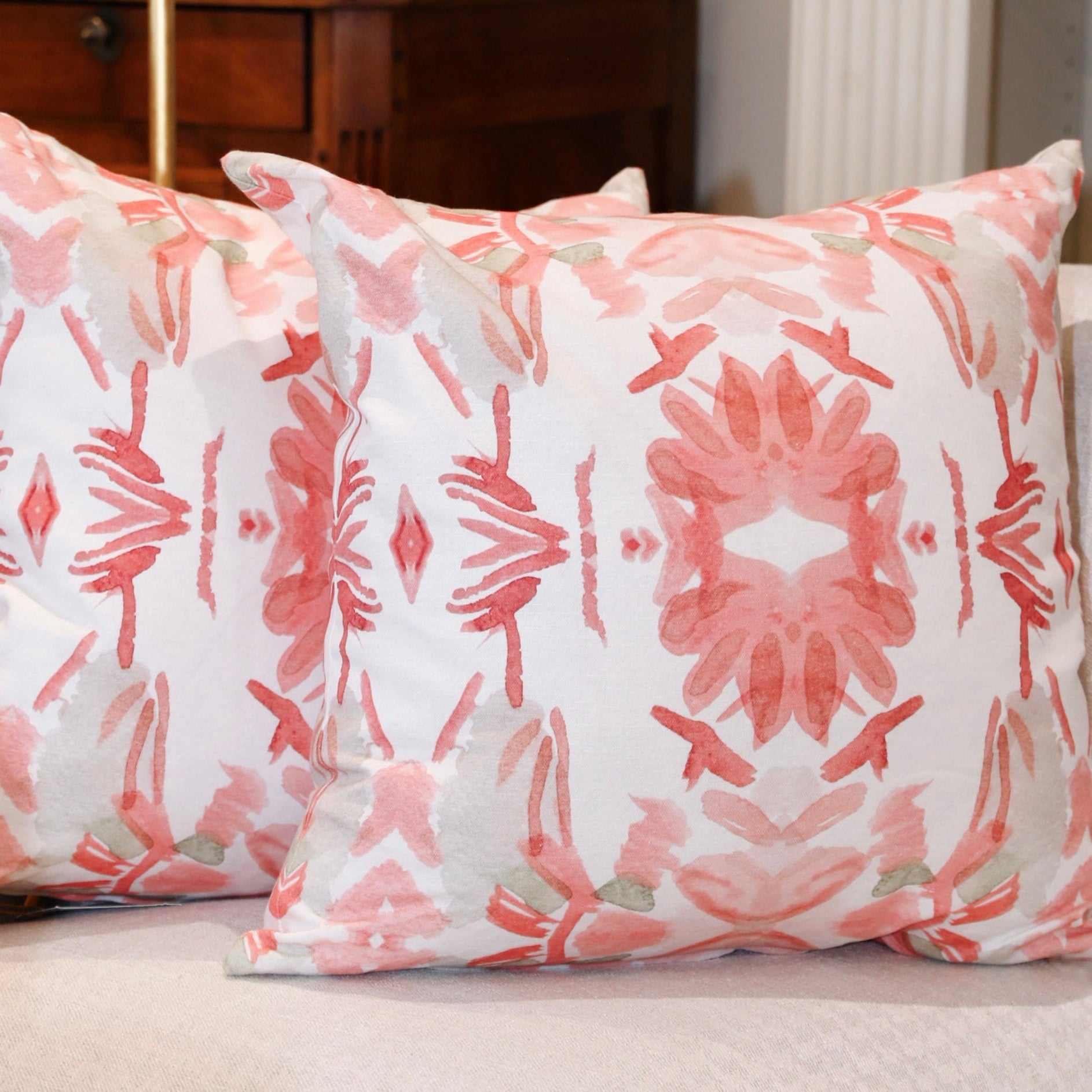 Wildflowers I Strawberry luxury decorative pillow featuring a large-scale abstract floral pattern in rich strawberry pink and red tones, handcrafted in England for luxury living rooms, designer-curated interiors, layered bedrooms, and modern traditional homes.